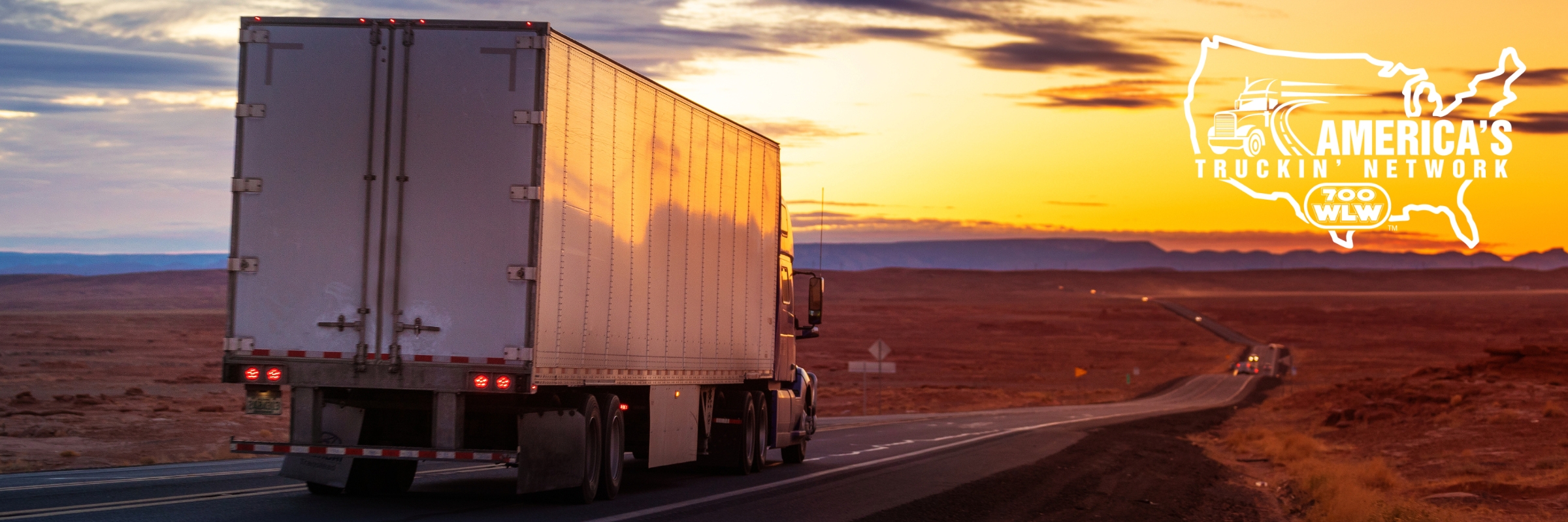 Semi truck driving down road with America's Truckin' Network logo overlayed