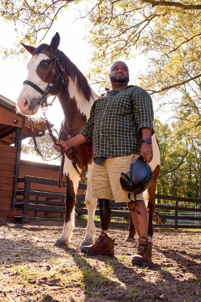 Chris Gordon standing next to horse