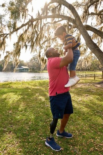 Chris Gordon holding son