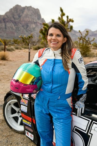 Melissa McMahon standing next to racecar